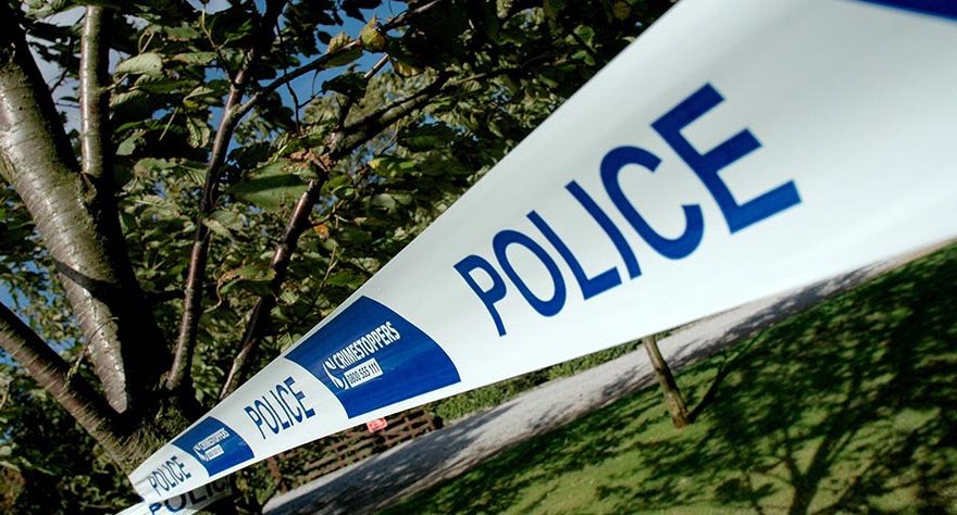 Photo of blue and white plastic tape carrying the word 'Police'.